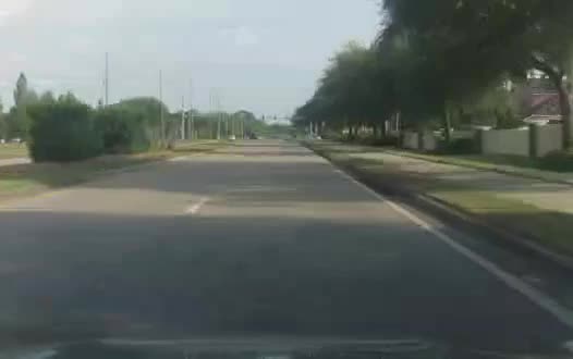 Toyota Camry forward-camera frame on an arterial road