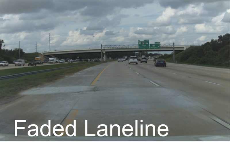 Faded lane line on an interstate approaching an overpass